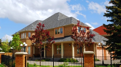 Big luxury residential house with iron fence