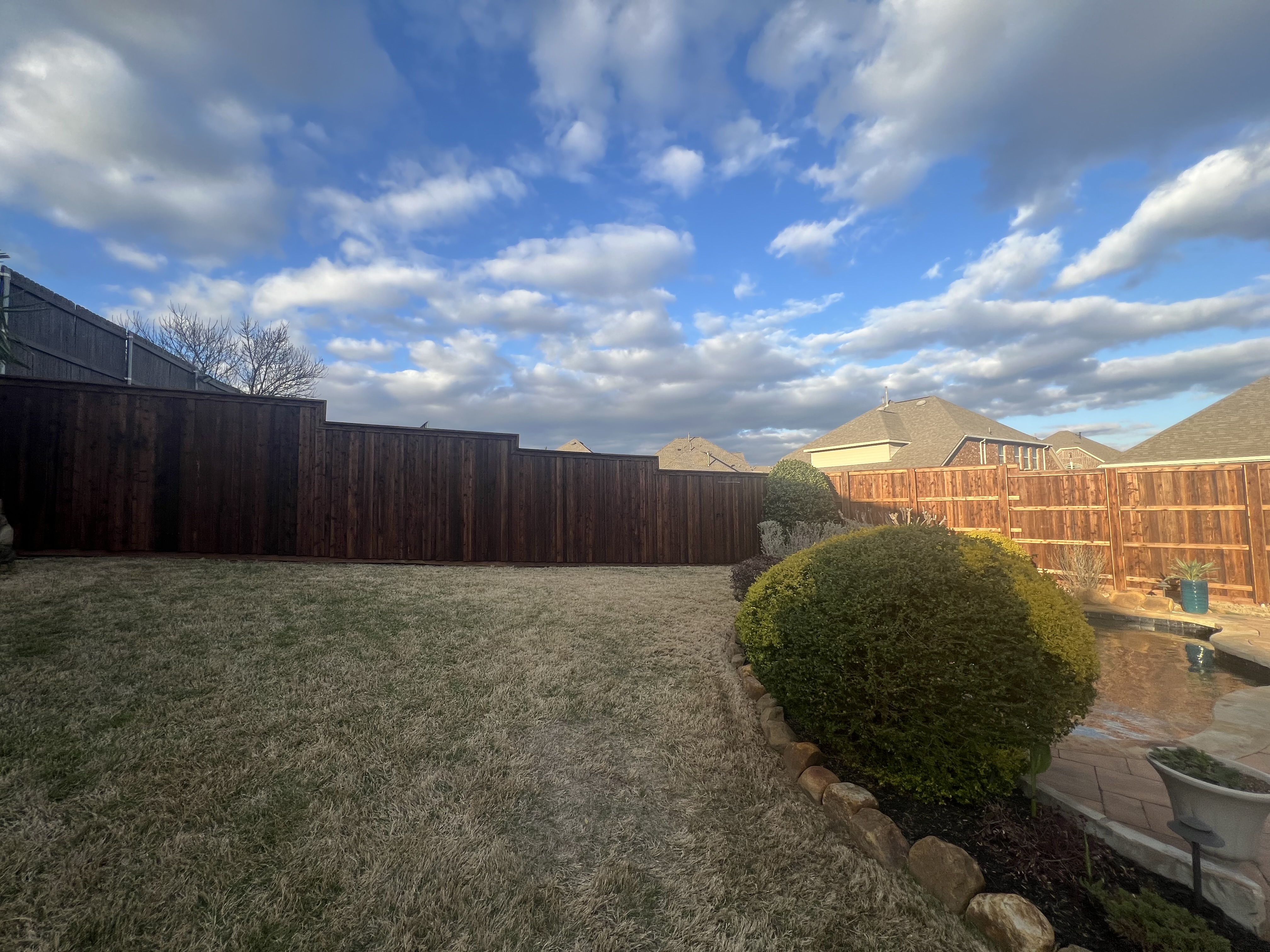 Cedar board on board stepped fence with cap and trim and posts boxed in