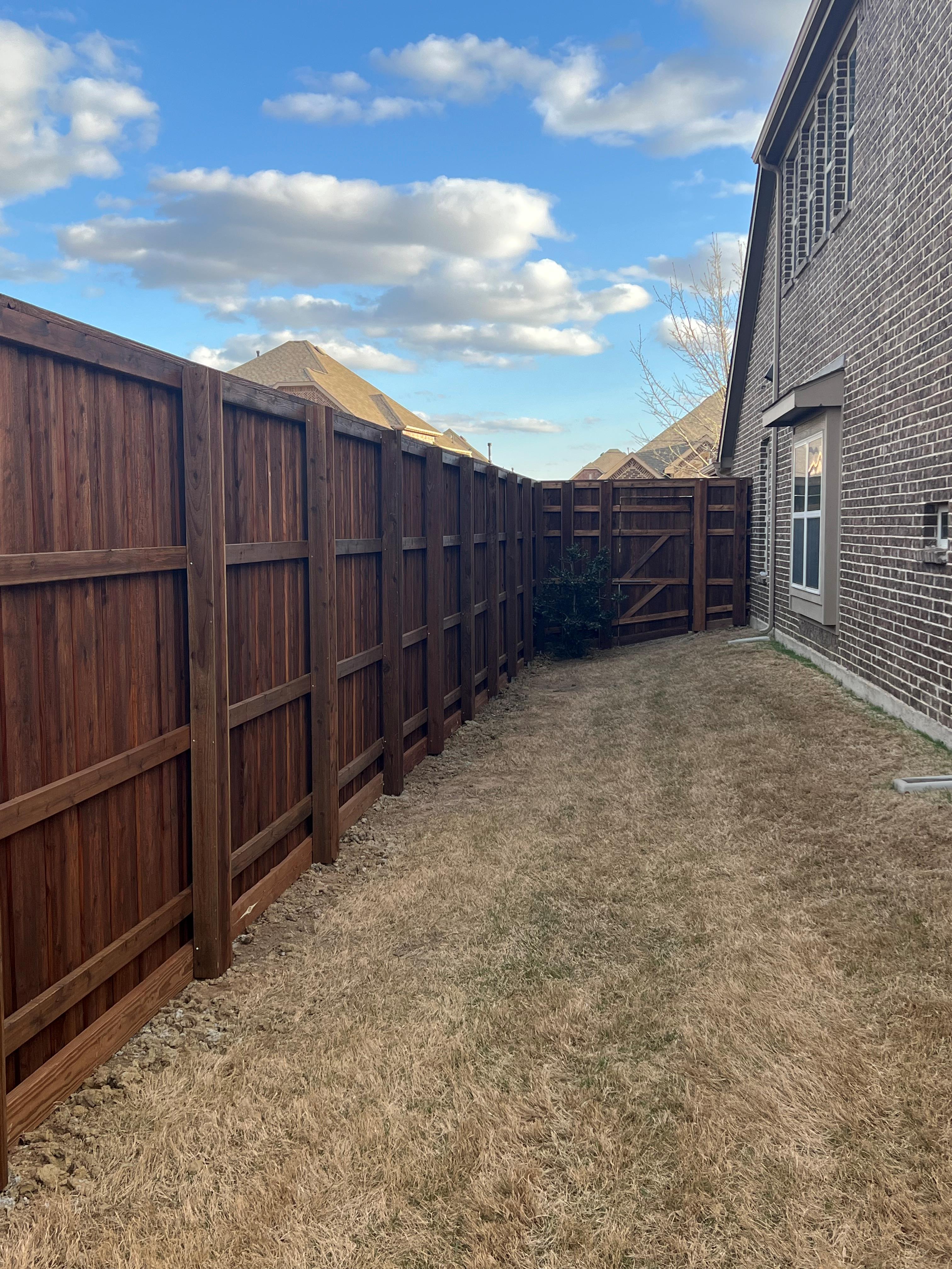 Side fence and front wing cedar board on board with posts boxed in