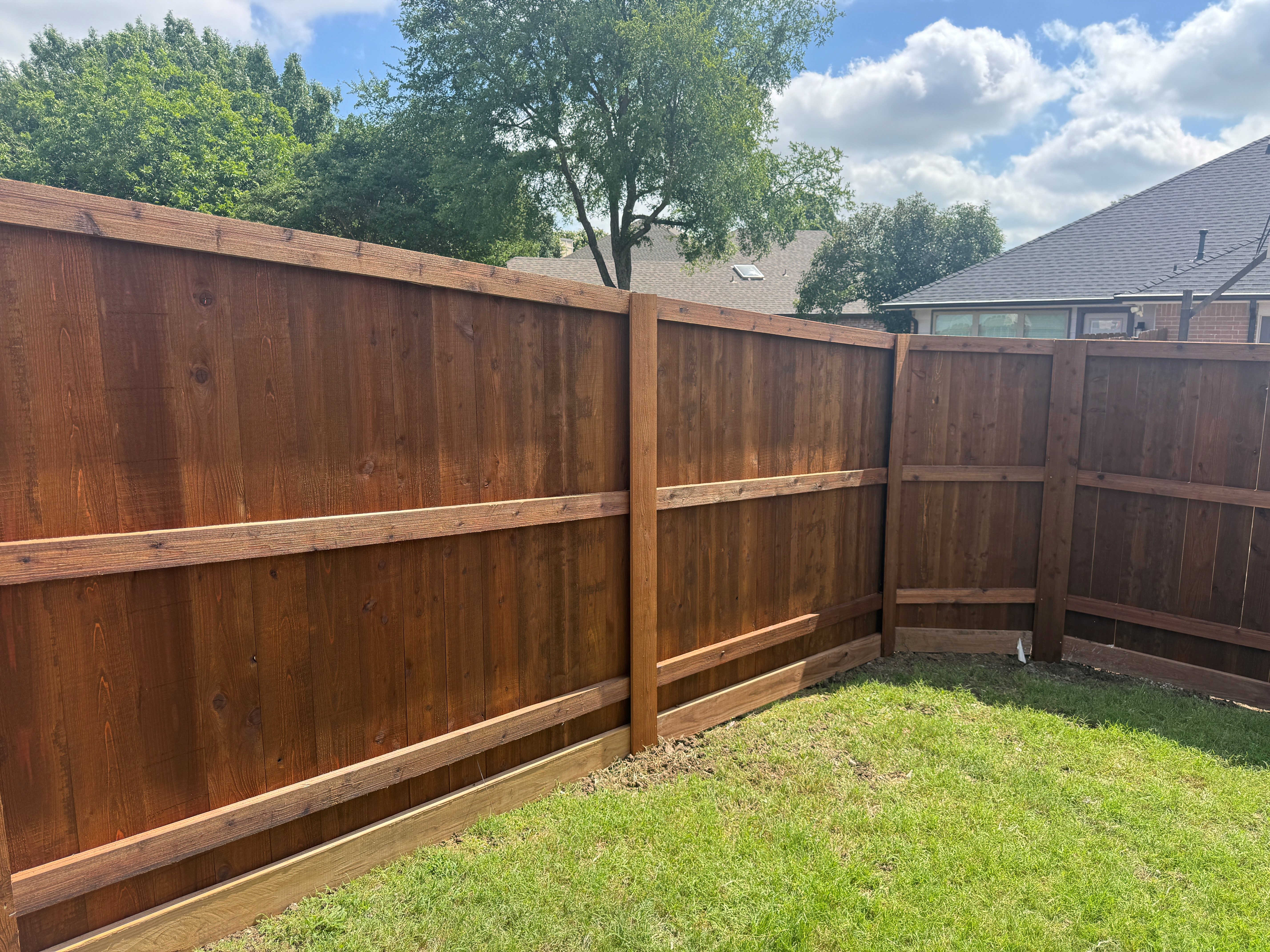 PostMaster+ posts installed on a 6' privacy fence with trim in Flower Mound