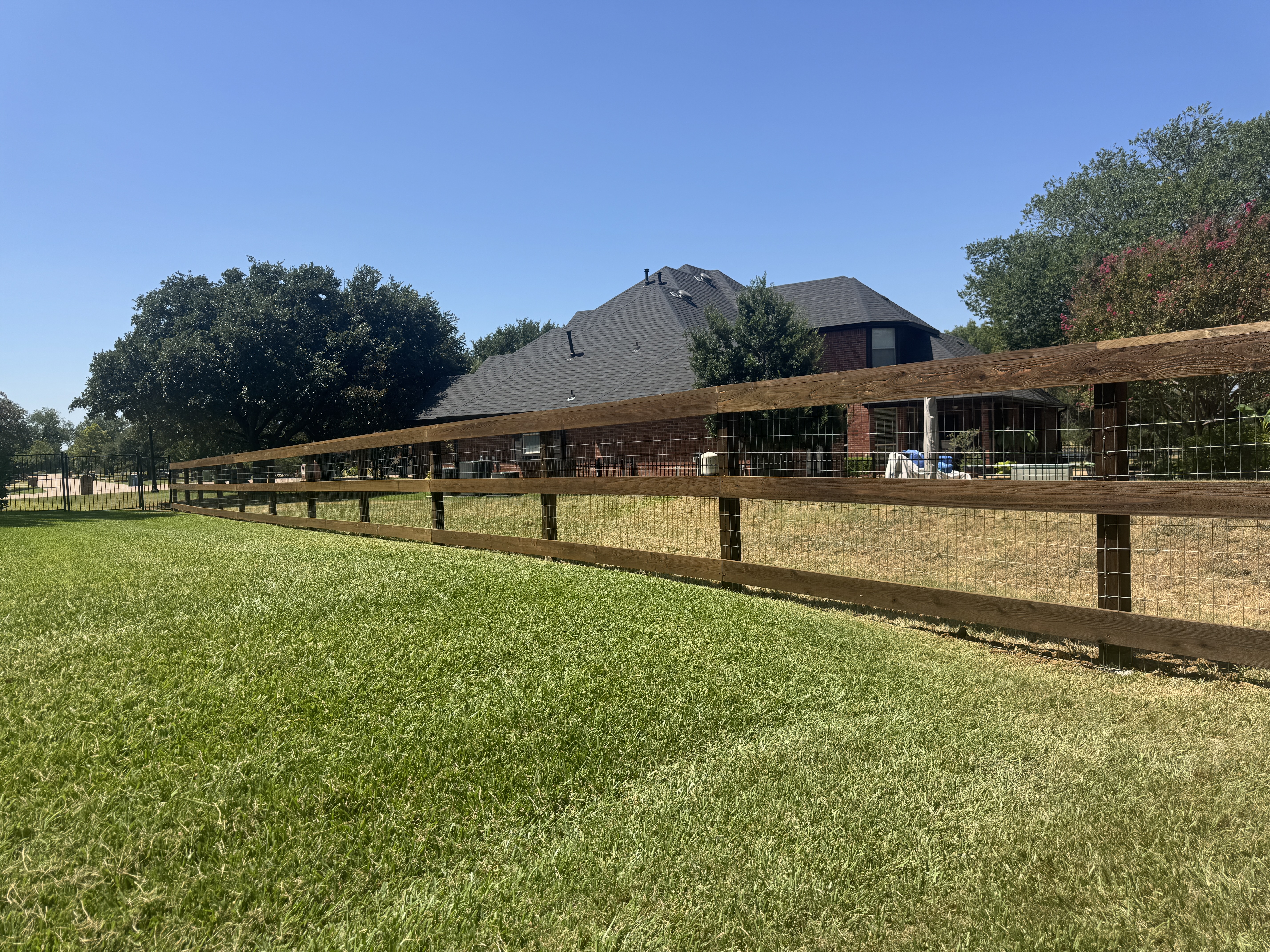 Double Oak - 4' high 3 rail cedar fence with top cap, custom stained dark walnut