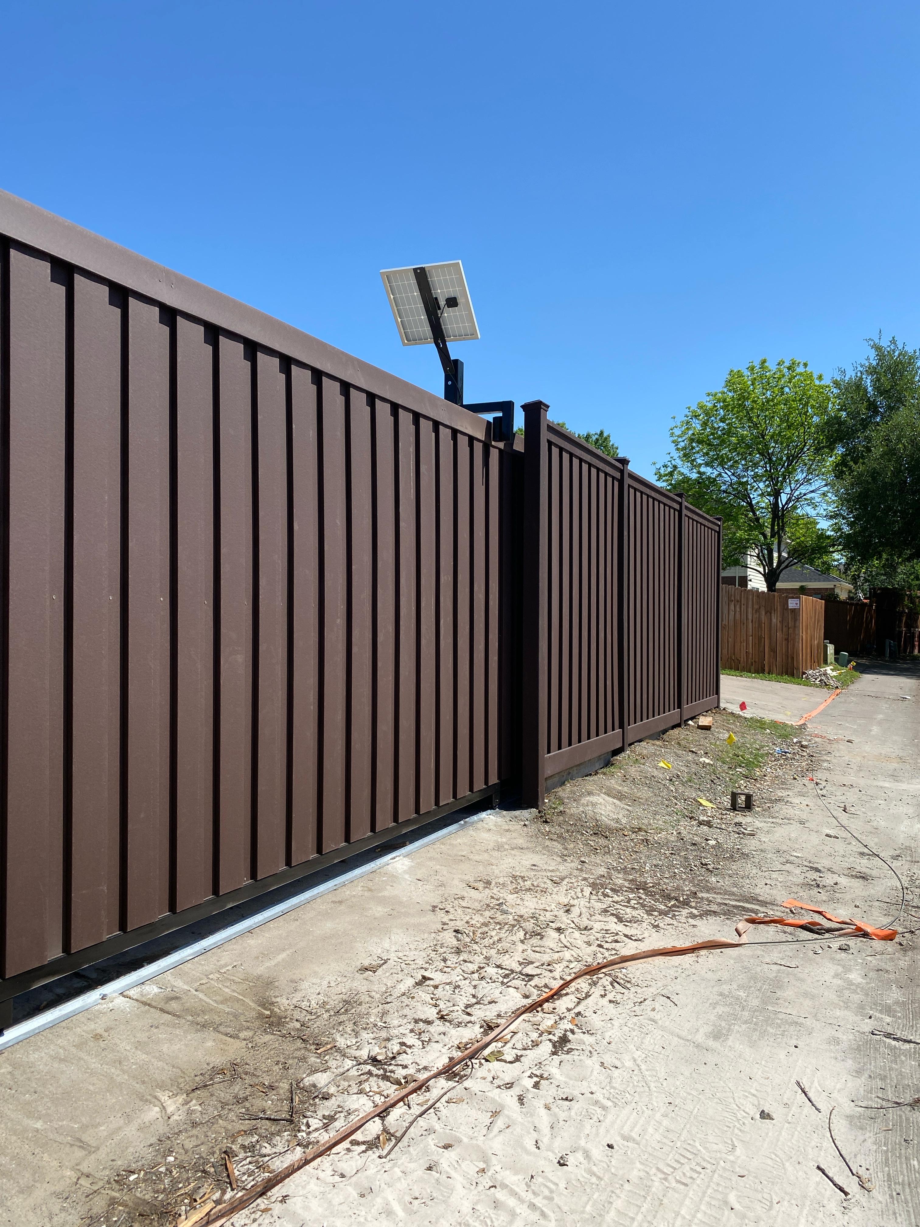 Trex composite fence with a 20 ft automated sliding gate (solar)